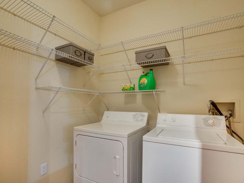This picture shows the full-size washer and dryer with unique types of storage.